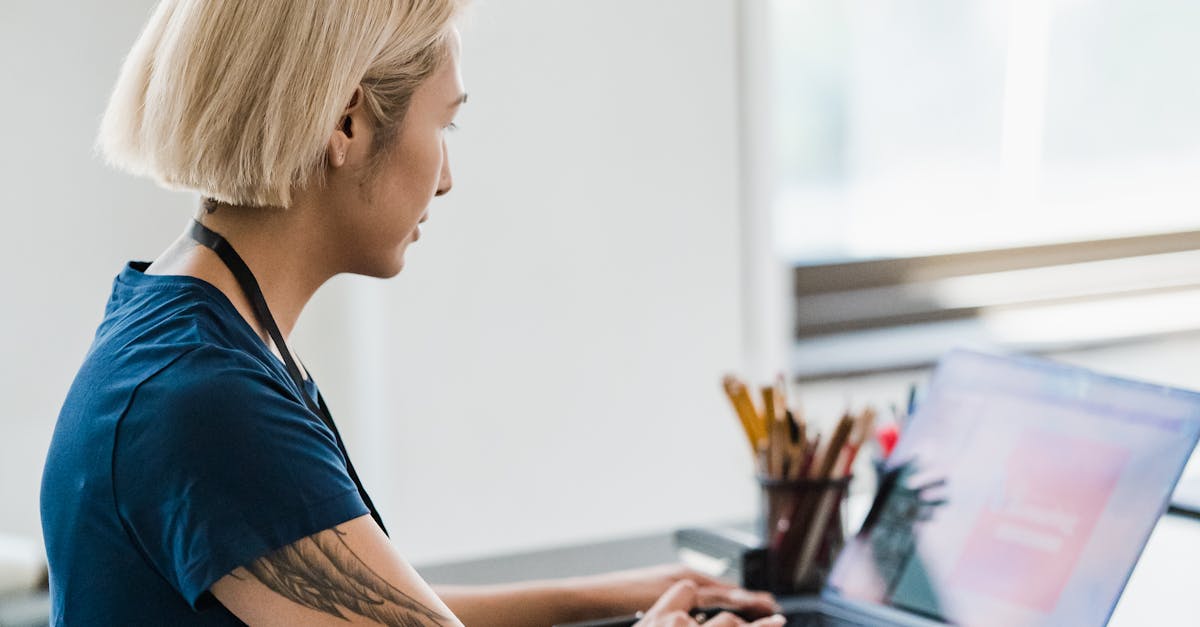 Consultant reviewing research responses on a laptop